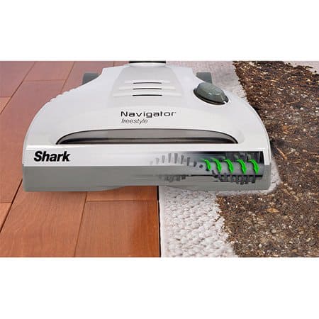 image shows the shark navigator head with the beater bar on both a carpet and a hardwood.