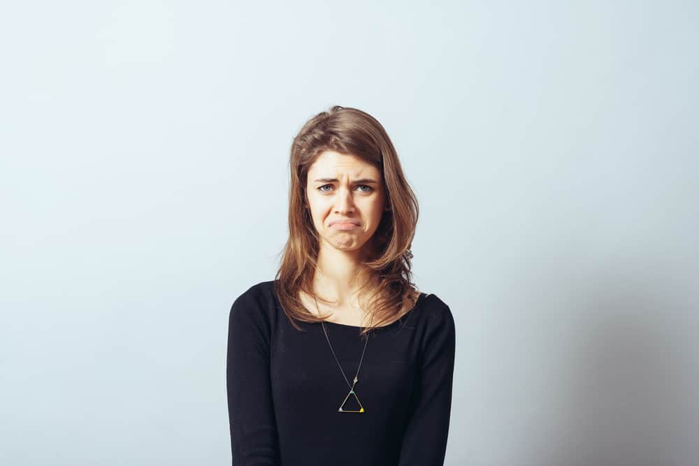 Woman looking annoyed at doing chores